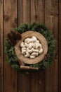 German Christmas pastry vanillekipferl. Crescent shaped biscuits in icing sugar in oak wood plate on fir tree wreath on rustic old Royalty Free Stock Photo