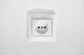 German circular recess socket with two round holes for 2 pins europlugs types C, E and F. Common cheap plastic AC power Royalty Free Stock Photo