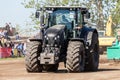 German claas axion tractor drives on track by a traktor pulling event