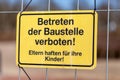 German construction side sign on a fence