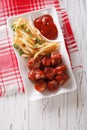 German cuisine: currywurst with french fries. Vertical top view Royalty Free Stock Photo