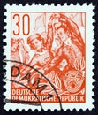 GERMAN DEMOCRATIC REPUBLIC - CIRCA 1953: A stamp printed in Germany from the `Five Year Plan` issue shows Folk dancers, circa 1953 Royalty Free Stock Photo