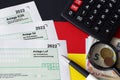 German different tax declaration blank forms - Anlage EUR, Anlage SZ and Anlage Luf. Documents lies with calculator, pen and