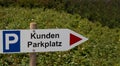 A German directional sign to a customer parking area