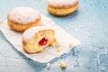 German donuts - berliner filled with strawberry jam with icing sugar Royalty Free Stock Photo