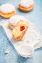 German donuts - berliner filled with strawberry jam with icing sugar Royalty Free Stock Photo