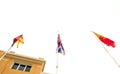 German English and Spanish flags in front of a building.