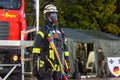 German fireman puppet stands near a fire engine on a presentation