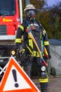 German fireman puppet stands near a fire engine on a presentation