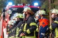 German firemen stands near a fire truck during an exercise Royalty Free Stock Photo