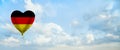 German flag on balloon against sky clouds background. Education, charity, emigration, travel and learning German language, Germany Royalty Free Stock Photo