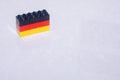 German flag black, red, and yellow made of toy blocks on a tile with a reflection and space to add concept. Royalty Free Stock Photo