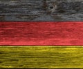 Weathered German flag colored wooden plank background. Texture with copy space Royalty Free Stock Photo