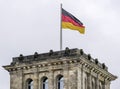 The German flag flies over the Reichstag Palace Parliament in Berlin, Germany Royalty Free Stock Photo