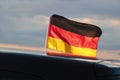 German flag flying on a car roof at sunset Royalty Free Stock Photo