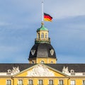 German Flag at Halfmast, auf Halbmast, on the top of Castle Karlsruhe. In Karlsruhe, Baden-WÃÂ¼rttemberg, Germany Royalty Free Stock Photo