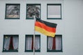 German flag on the outside of the building next to the windows. Patriotic sentiments before the elections.