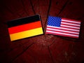 German flag with USA flag on a tree stump Royalty Free Stock Photo