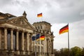 The German flag waves at the Bundestag, the building of the German parliament. Cloudy sky Royalty Free Stock Photo