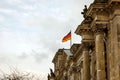 The German flag waves at the Bundestag, the building of the German parliament. Cloudy sky Royalty Free Stock Photo