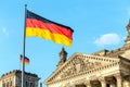 German flags waving at the famous building, seat of the German Parliament, politics and tourism concept Royalty Free Stock Photo