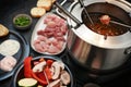 German fondue with raw meat and vegetables to be fried on long forks in a pot with boiling oil, often served for family and Royalty Free Stock Photo