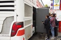 German and foreigner travelers people receive baggage from store room of bus