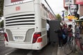 German and foreigner travelers people receive baggage from store room of bus