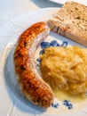 German Franconian bratwurst with sauerkraut and bread Royalty Free Stock Photo