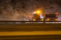 German highway snow plow at night