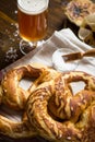 Homemade Pretzel with Sea Salt and Glass of Beer on Rustic Wooden Table Royalty Free Stock Photo