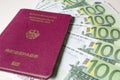 German international traveling passport and euro money.