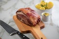 German Kassler pork neck with boiled potatoes and mustard on marble table