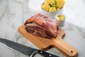 German Kassler pork neck with boiled potatoes and mustard on marble table