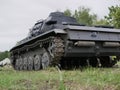 German medium tank of the Second World war in working order. the tank is painted black against a background of green trees in summ Royalty Free Stock Photo