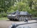 German medium tank of the Second World war in working order. the tank is painted black against a background of green trees in summ