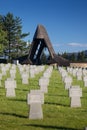 German military cemetery in autumn with mountains in the background and many graves of soldiers killed in the Second World War. Royalty Free Stock Photo