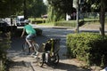 German mother people biking and children in stroller go to home