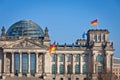 German National flag waving in front of German parliament building in Berlin Royalty Free Stock Photo