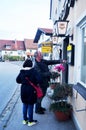 German old man people and thai old woman travel visit reading menu and select local restaurant in evening time winter season at Royalty Free Stock Photo