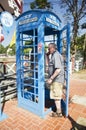 German old man people using public telephone tell to family at Royalty Free Stock Photo