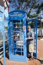 German old man people using public telephone tell to family at Royalty Free Stock Photo