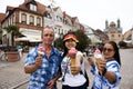 German old man and thai woman people show ice cream and eating at Speyer town