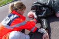 German paramedic check blood pressure on an injured biker