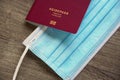 German passport reisepass and medical face mask - travel during corona covid pandemic