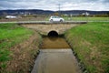 German people driving eco car on street road crossing irrigation canal and view landscape rural countryside farmland plantation at Royalty Free Stock Photo