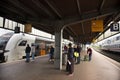 German people and foreign travelers walking waiting got to train in terminal at Dortmund Central Hauptbahnhof railway station on