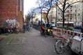 German people stop and lock bike at bicycle parking beside road