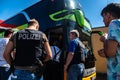 German policemen and crowd of people at the bus stop