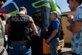 German policemen and crowd of people at the bus stop